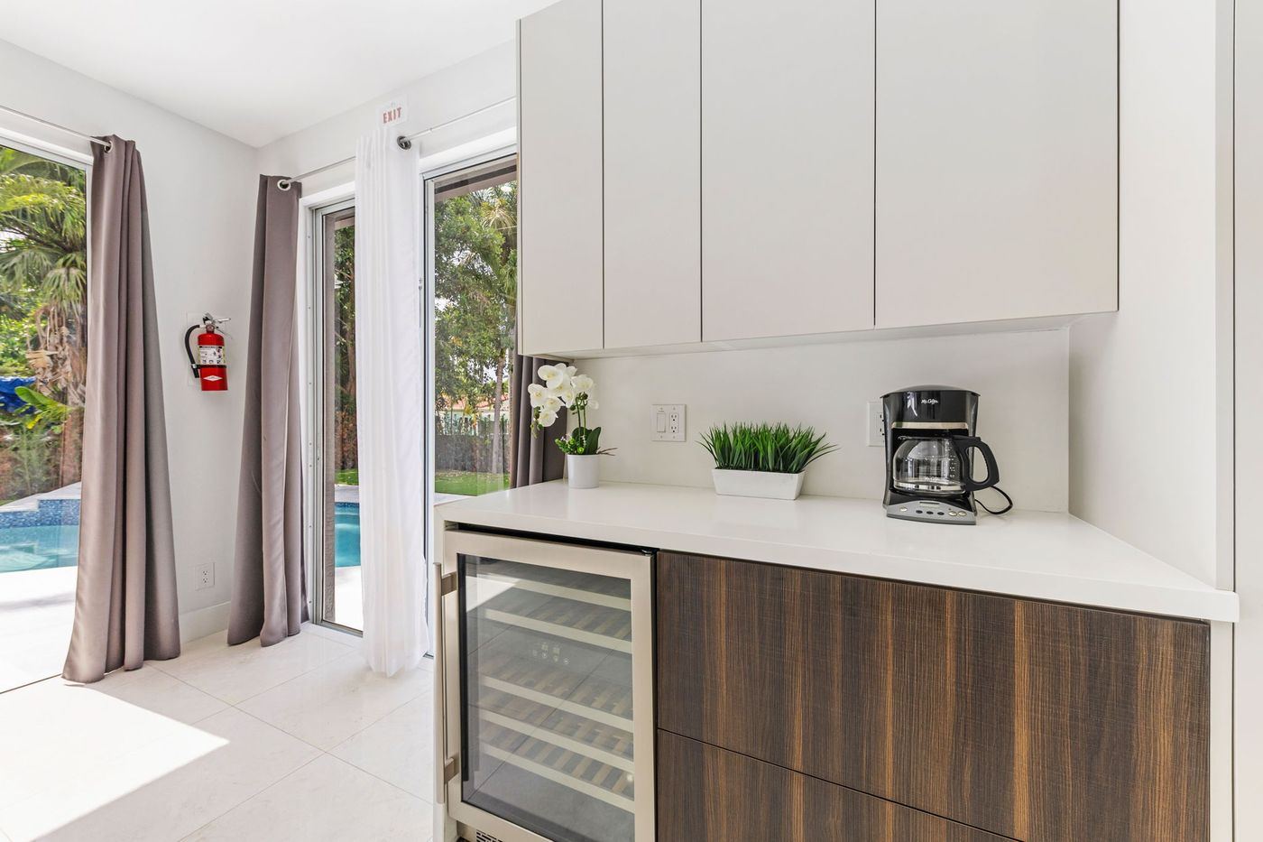 Kitchen with waterfall island overlooking the pool, kitchen remodel by MySFContractor