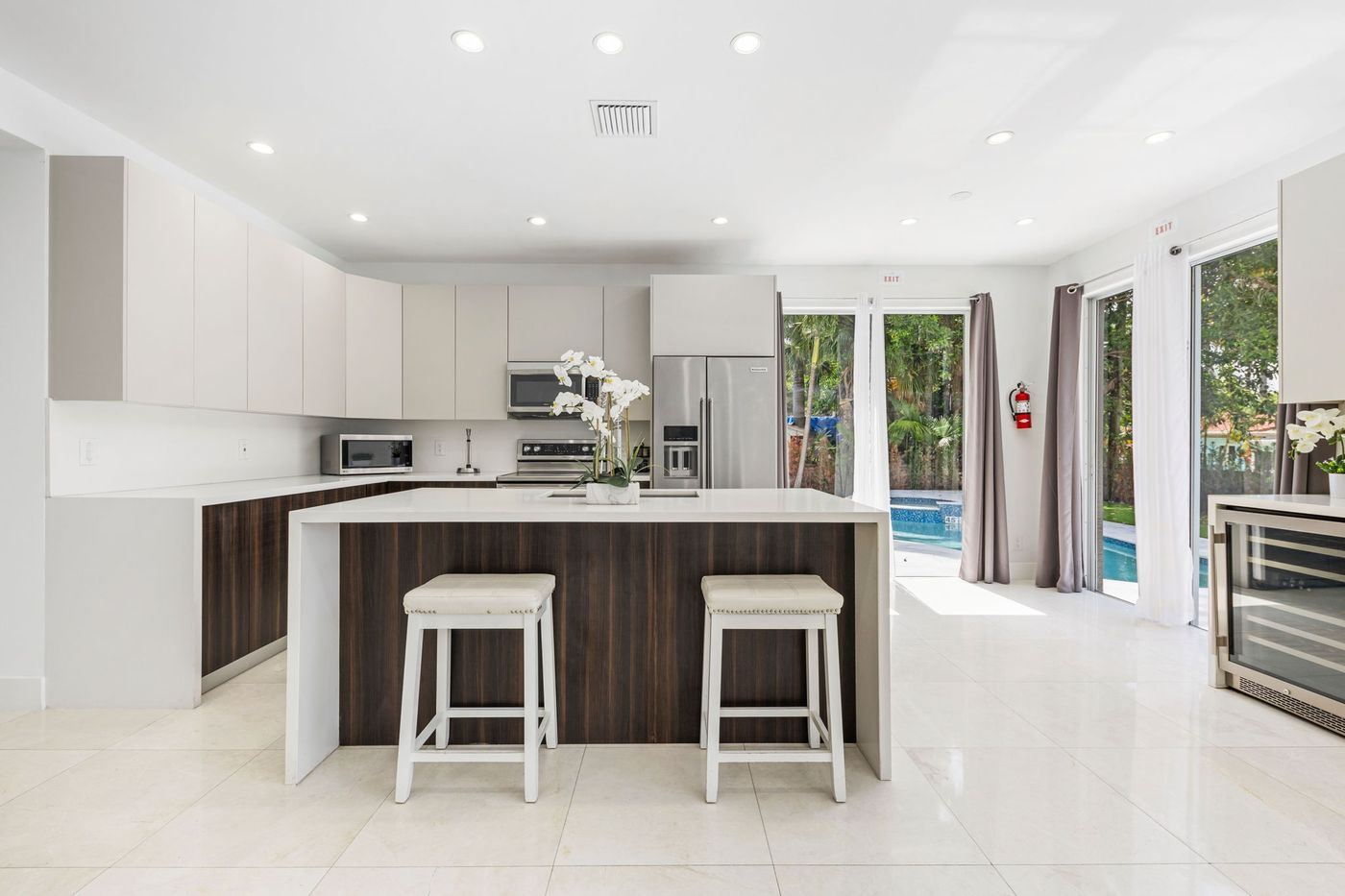 Kitchen island with glass doors to the pool, kitchen remodel by MySFContractor