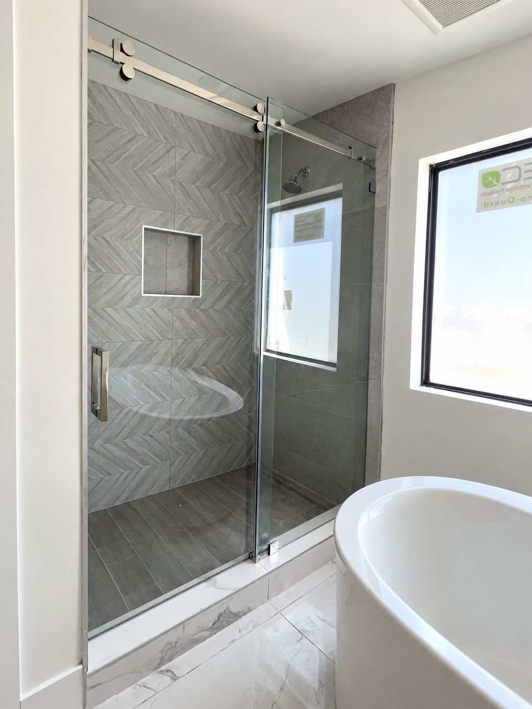 Sliding barn-door glass shower with chevron tile, bathroom remodel by MySFContractor
